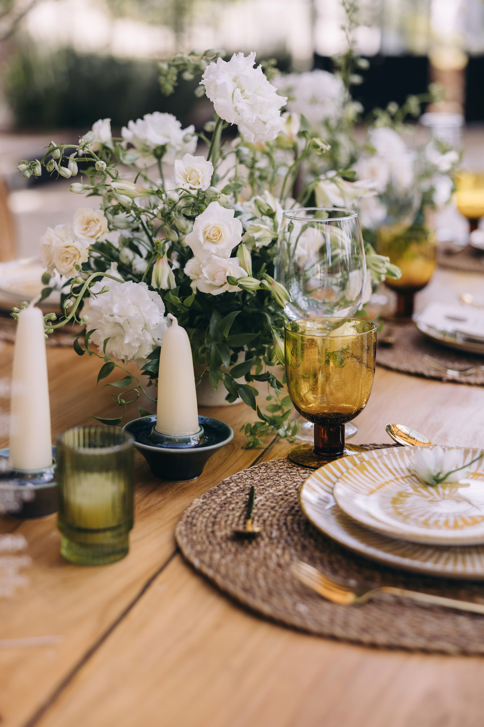A wedding tablescape with candles and glassware