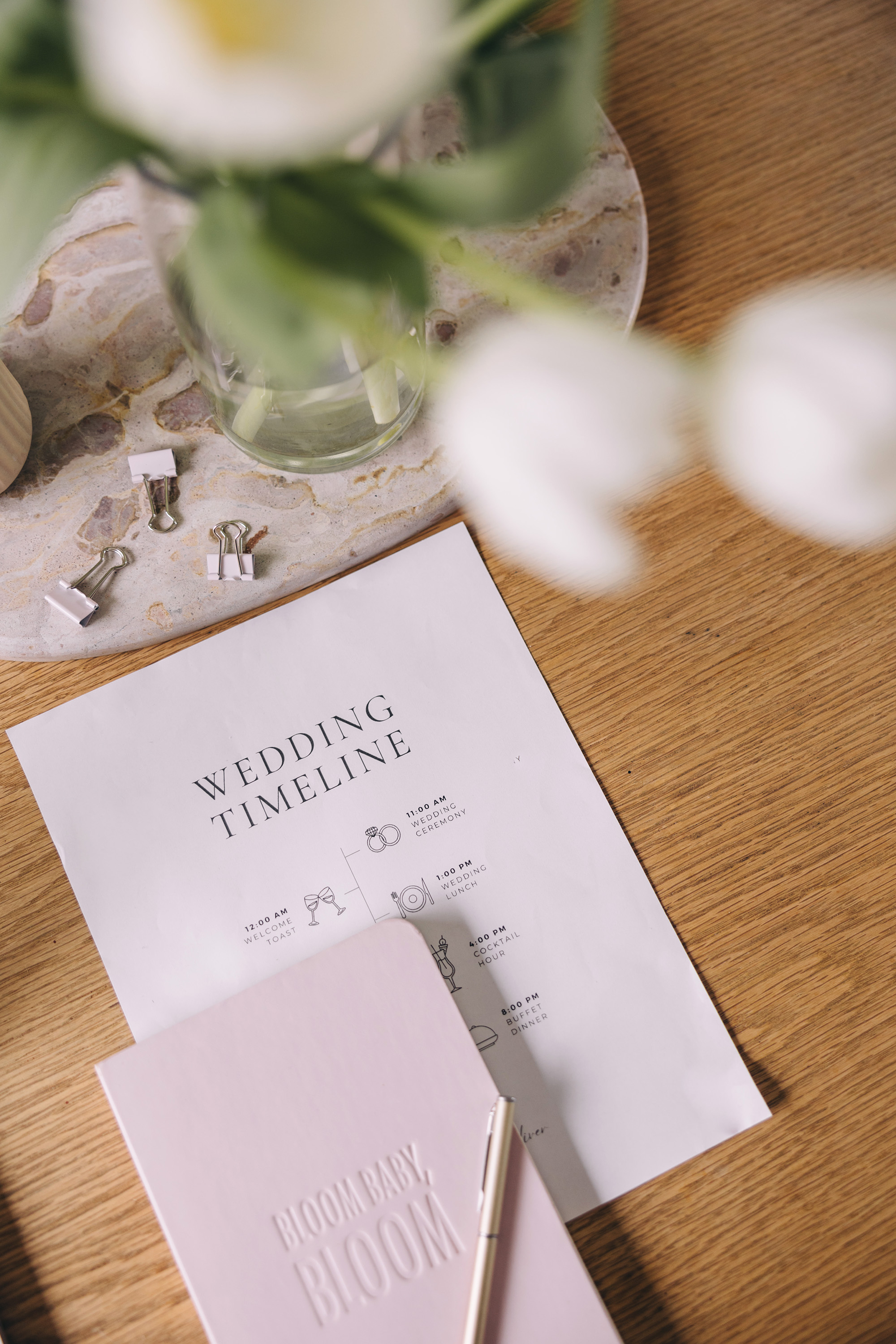 A printed wedding timeline on a desk
